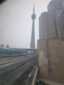 CN Tower Toronto photographed from railway tracks – urban architecture and skyline by Daniel Wisniewski.