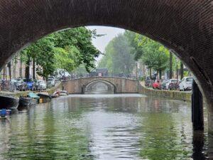 Amsterdam canal with historic houses and trees