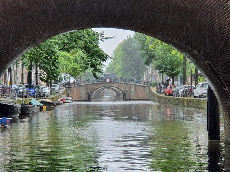 Amsterdam canal with historic houses and trees